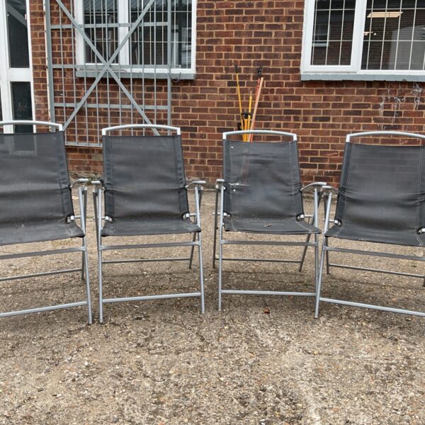 Set of four foldable garden chairs for outdoor use.