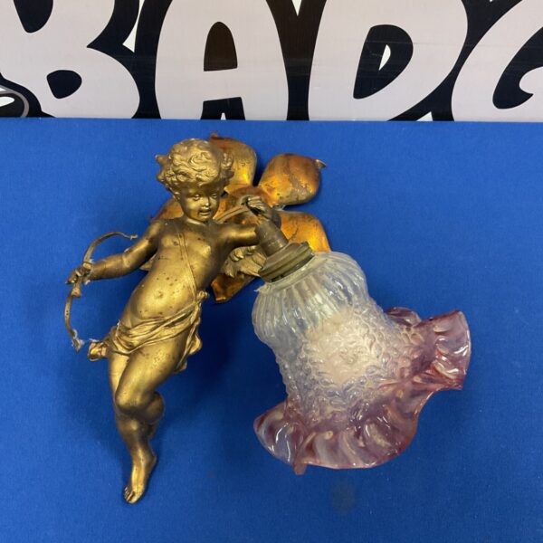 Antique French Cupid wall light with pink glass shade.