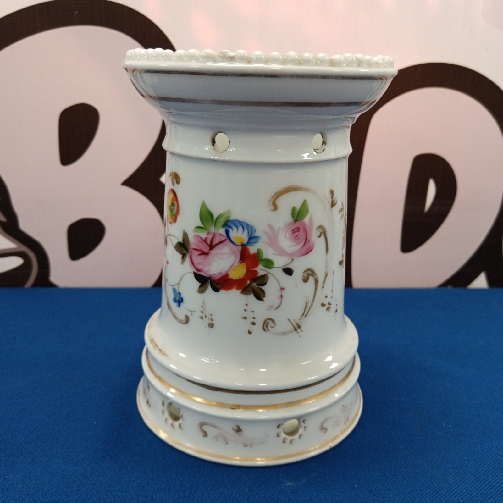 Antique French porcelain teapot warmer with delicate floral painting.
