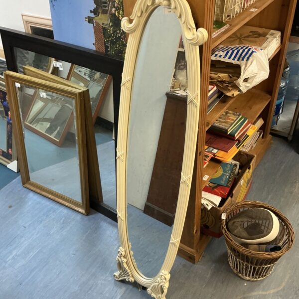 Ornate full length mirror with a gilded frame, antique bedroom decor.