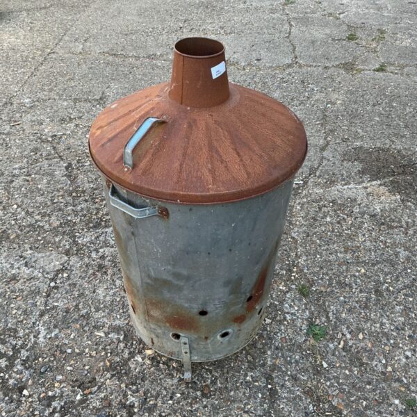 Weathered galvanised steel incinerator for garden waste disposal.