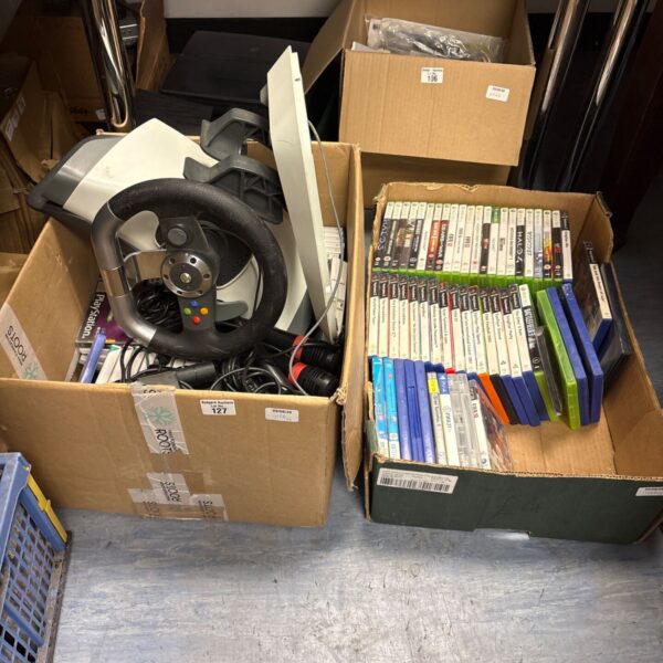 Gaming bundle with Logitech racing wheel and PS2 games.