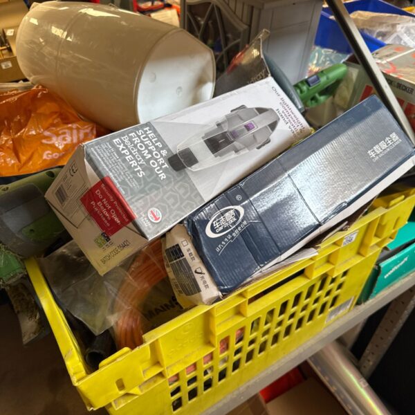 Garage clearance lot with handheld hoovers and a strimmer visible.
