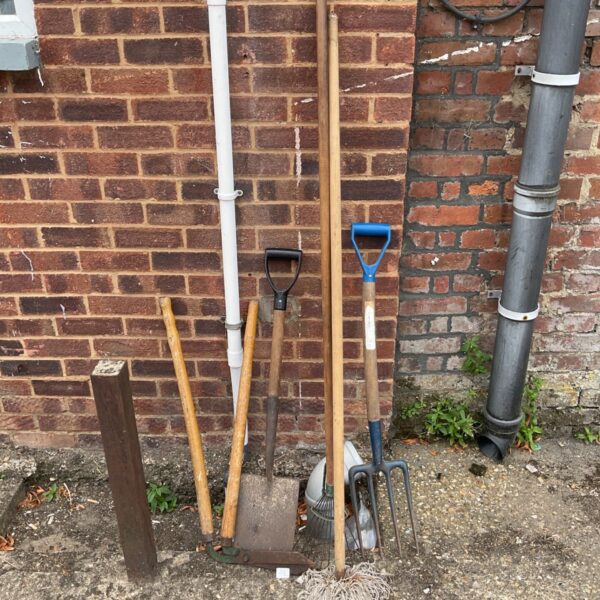 Garden tool lot including a spade, fork and mop.