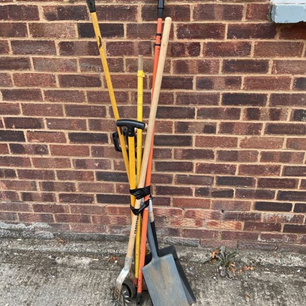 Garden tool lot featuring shovels and a spade for outdoor work.
