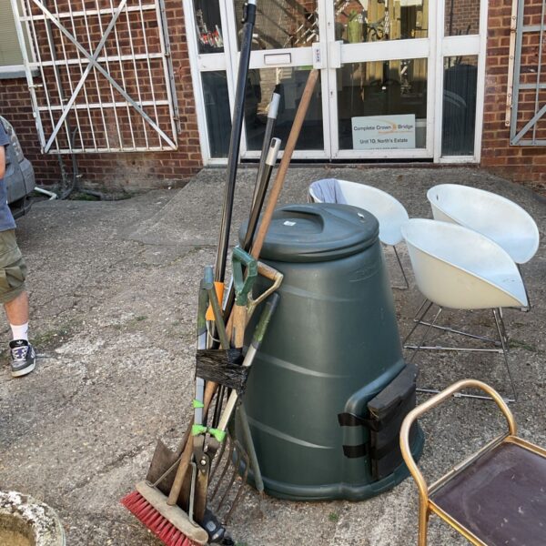 Job lot of used garden tools including a broom and fork.
