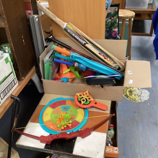 Mixed lot of colourful garden toys including a dart board and tennis rackets.