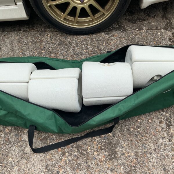 Set of four heavy-duty gazebo anchors in a green storage bag.