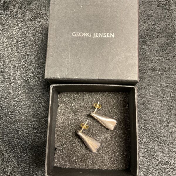 Georg Jensen silver earrings displayed in a black presentation box.