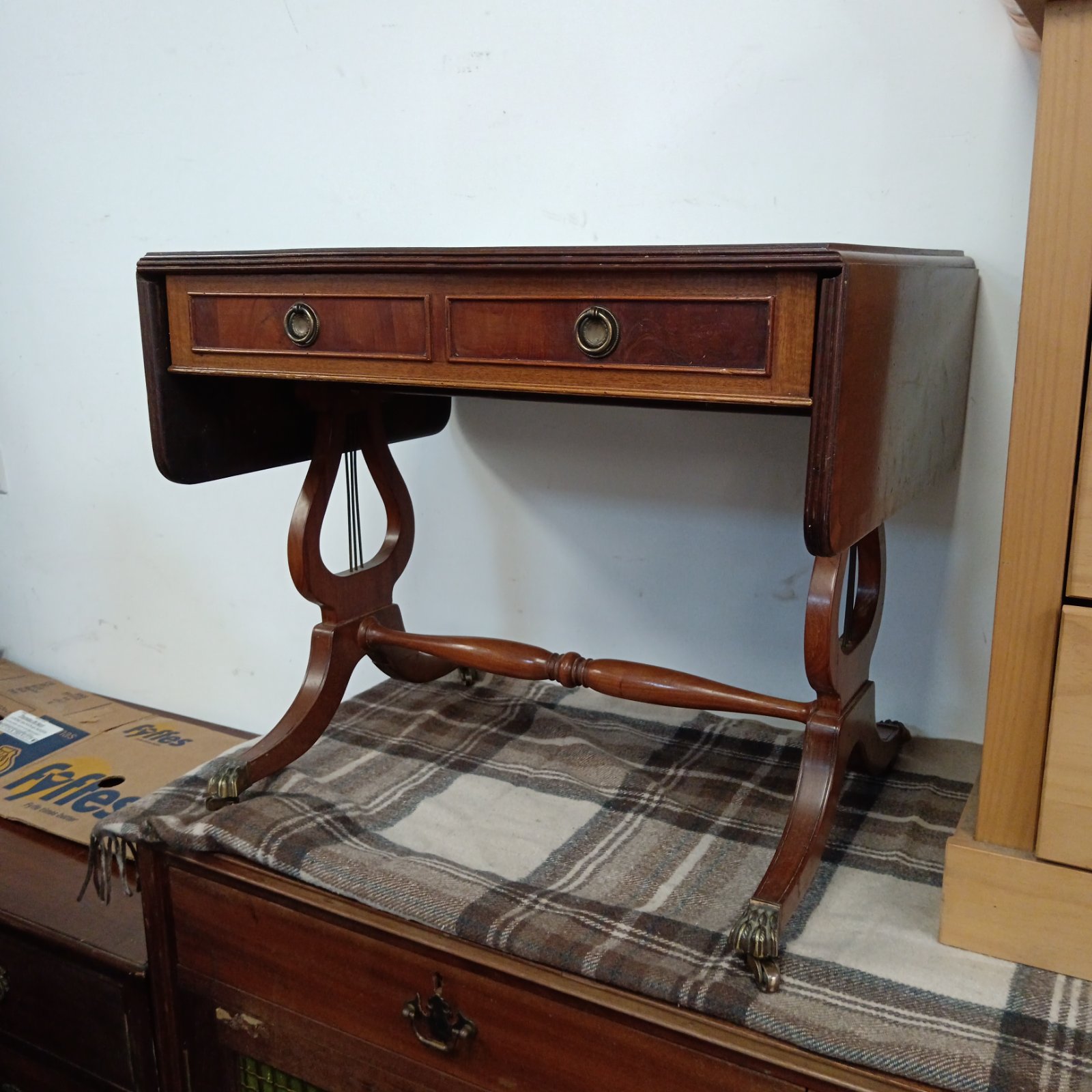 Reproduction Georgian mahogany drop leaf table with lyre legs.