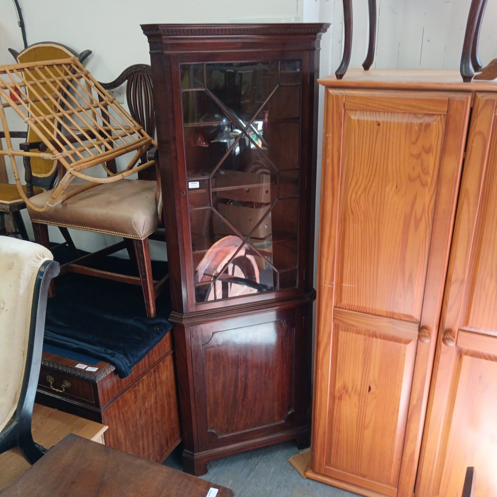 Reproduction Georgian mahogany corner cabinet in a room setting.