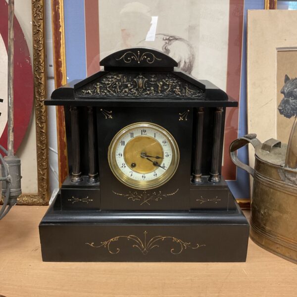 Antique German slate mantle clock with Roman numeral face.