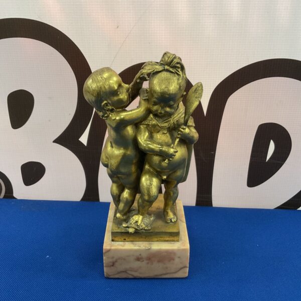 Antique gilt bronze putti figures in tribal dress on marble bases.