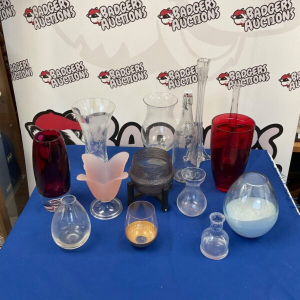 Assorted colourful glass vases and candle holders for home decor.