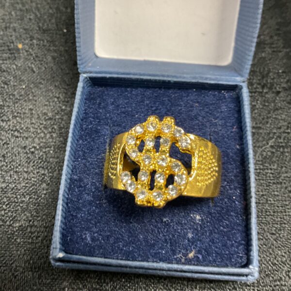 Gold tone dollar sign ring with clear stones.