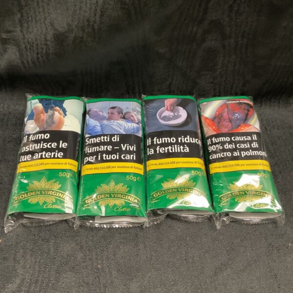 Four packs of Golden Virginia rolling tobacco with Italian warnings.