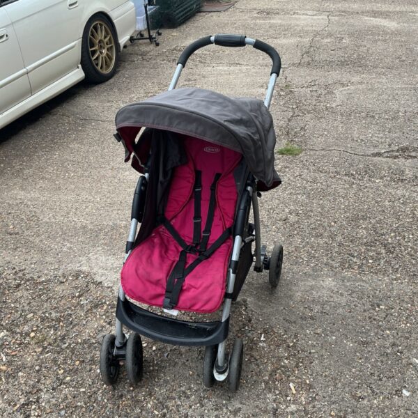 Pink and grey Graco lightweight stroller with adjustable canopy.