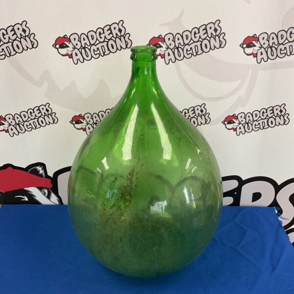 Large green glass terrarium bottle for botanical displays.