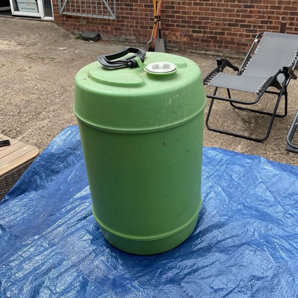 Green plastic liquid bladder for storage, showing signs of use.