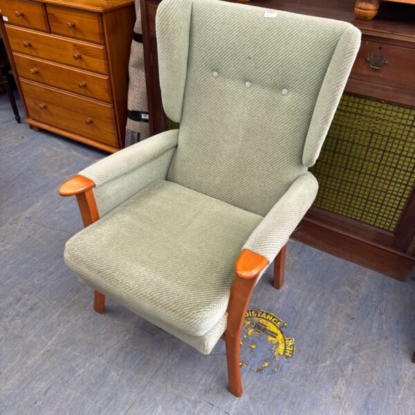 Light green wingback armchair with pine wood legs.