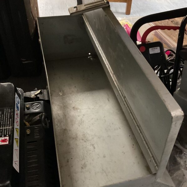 Grey metal poultry feeder trough for livestock feeding.