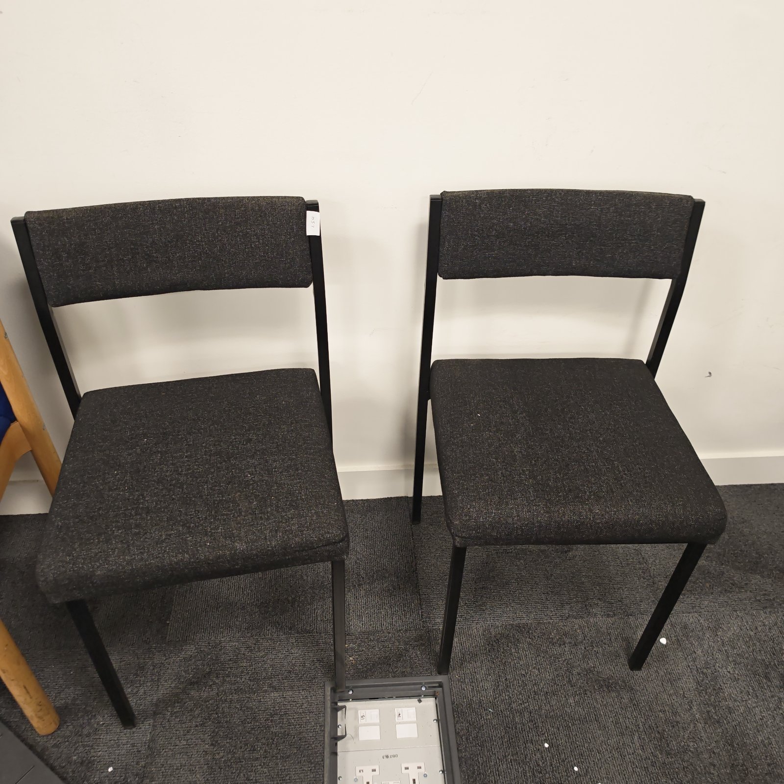 Two grey office reception chairs with black metal frames.