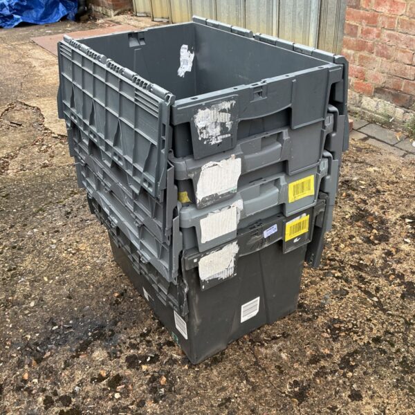 Stack of grey plastic distribution crates for storage and transport.