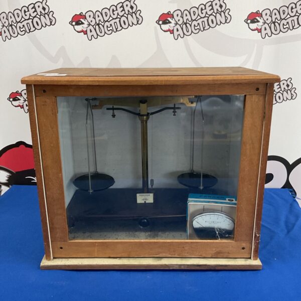 Vintage Griffin & George laboratory scales in a glass display case.
