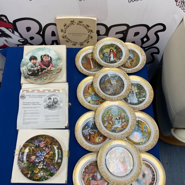Lot of vintage Grimms Fairy Tales collectors plates for display.