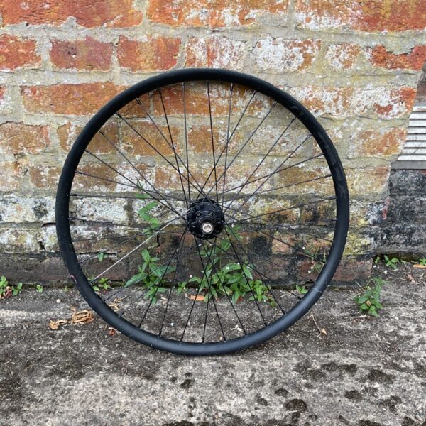 Black GT Performa 24 inch bicycle wheel for repair.
