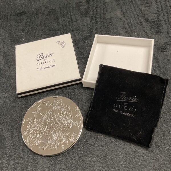 Gucci Flora compact mirror with floral design, vintage collectible.