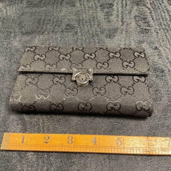 Front view of a vintage Gucci GG canvas wallet.