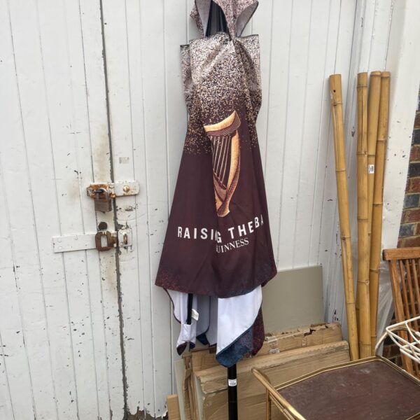 Vintage Guinness parasol with iconic harp branding.