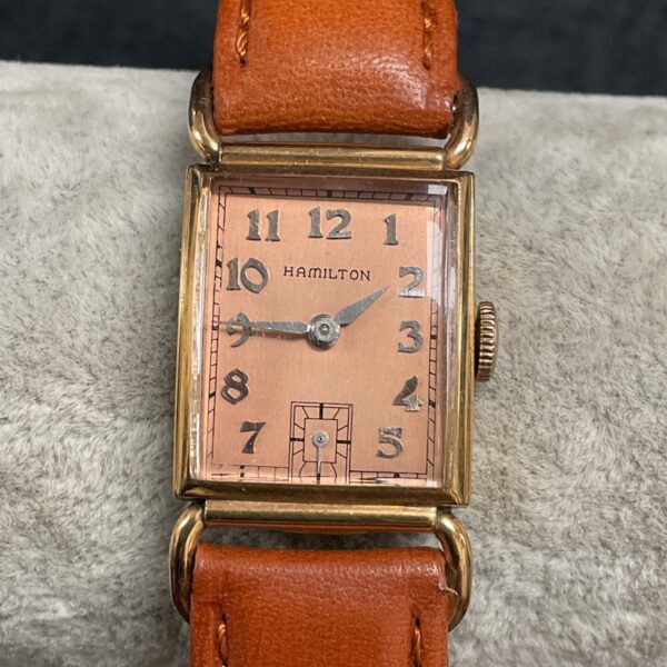 Vintage Hamilton Essex wristwatch with rose gold case and leather strap.