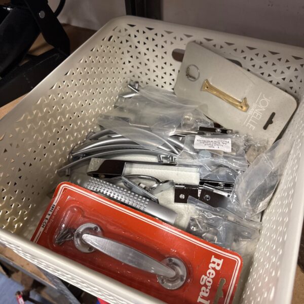 Tray of mixed hardware including hinges and handles.