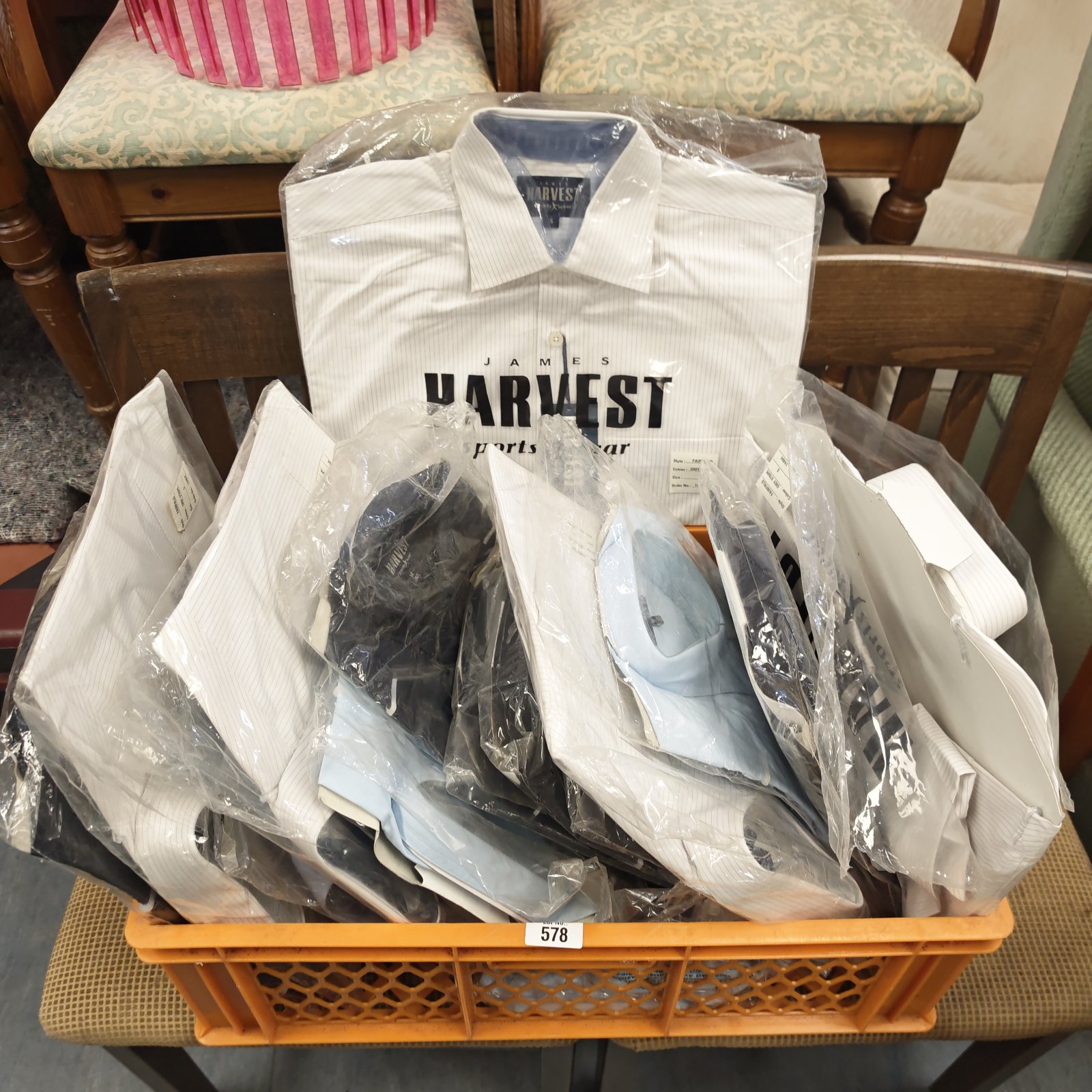 Crate of unopened Harvey's sportswear shirts for men and women.