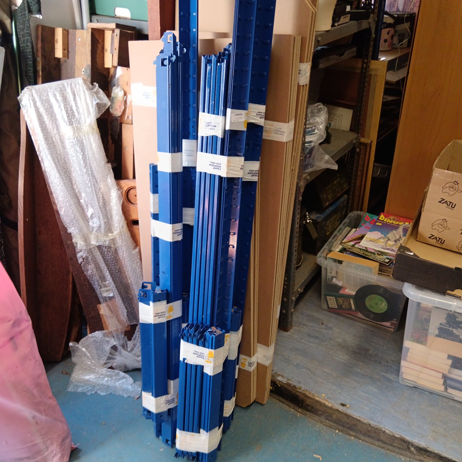Blue heavy duty racking uprights bundled for storage.