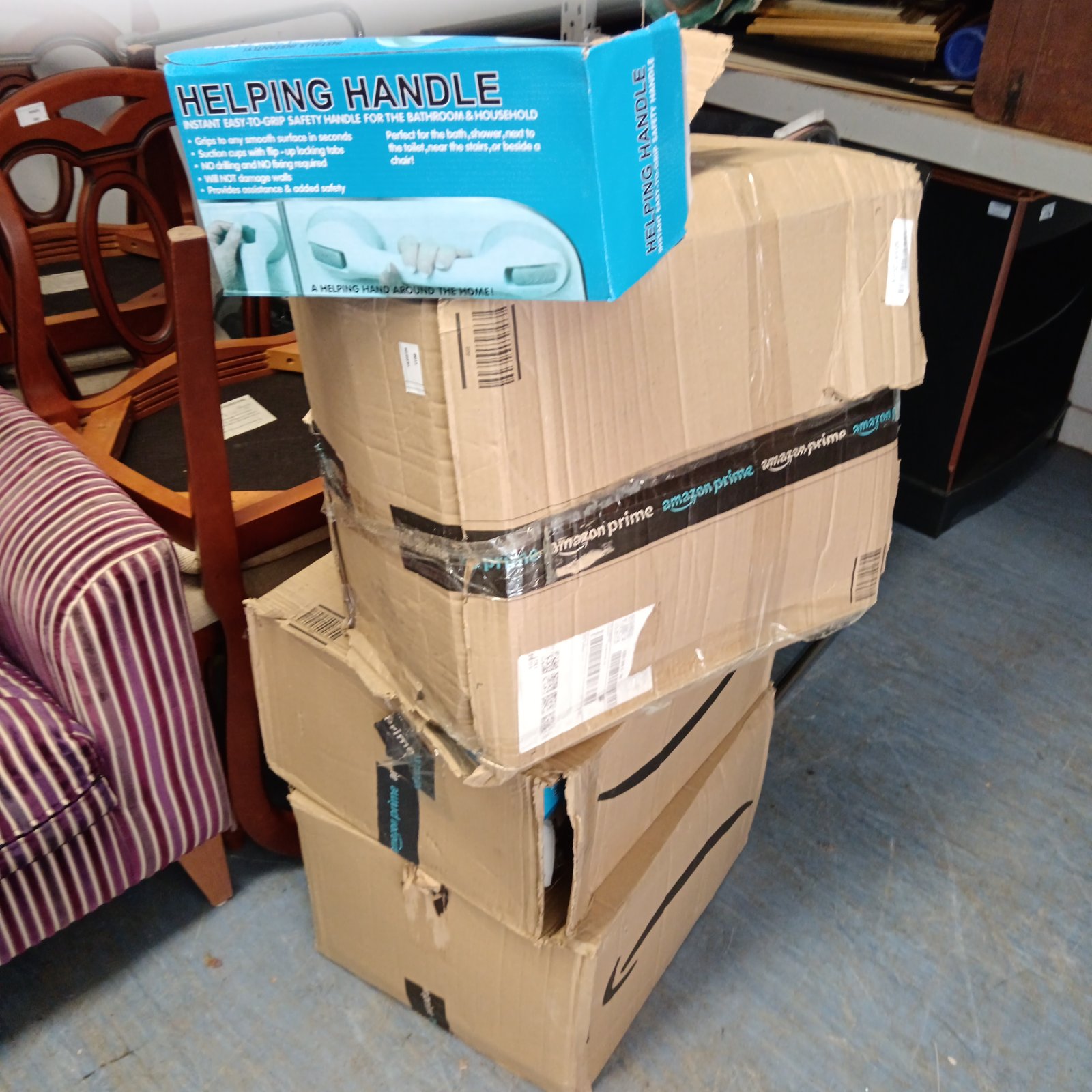 Stack of three boxes containing helping handles for bathroom safety.