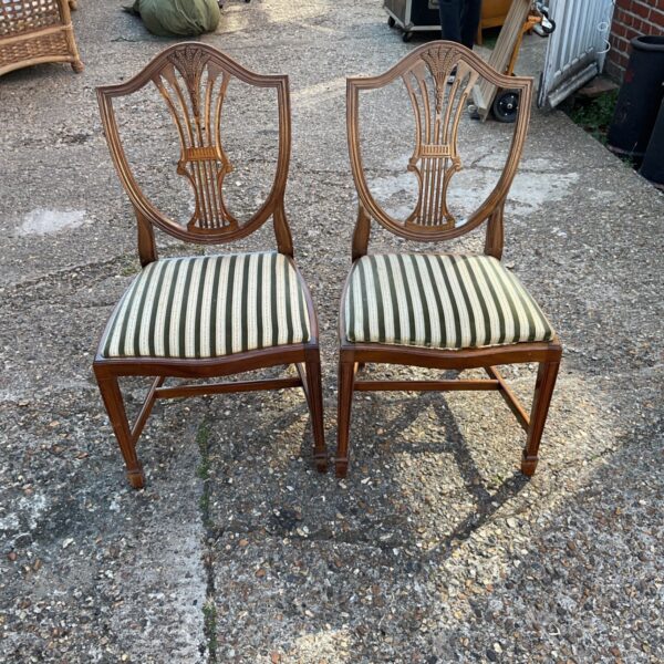 Pair of antique Hepplewhite style mahogany dining chairs with striped seats.