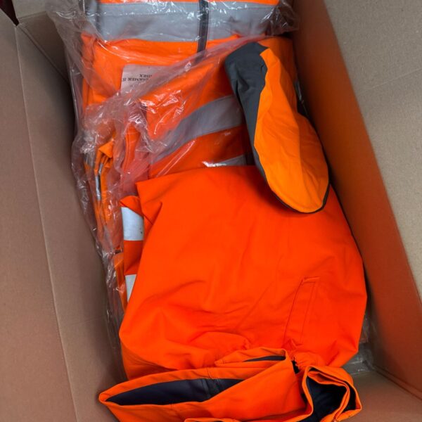 Bright orange high visibility workwear lot including jackets and trousers.