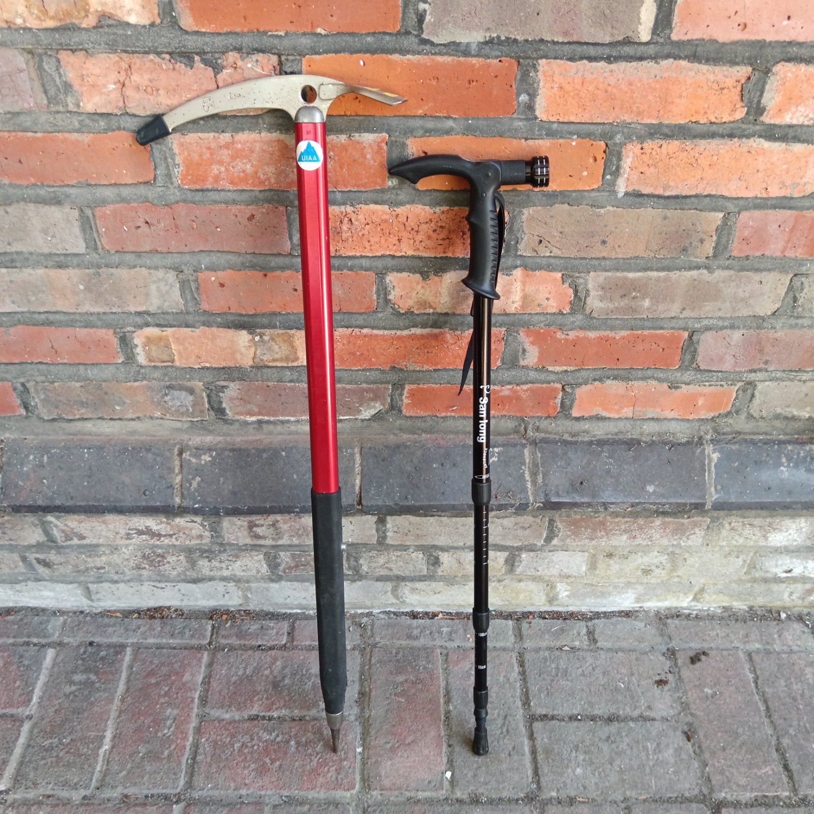 Hiking stick with torch and compass alongside a UIAA pickaxe.