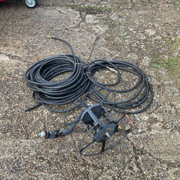 Black garden hose neatly wound on a plastic hose reel.