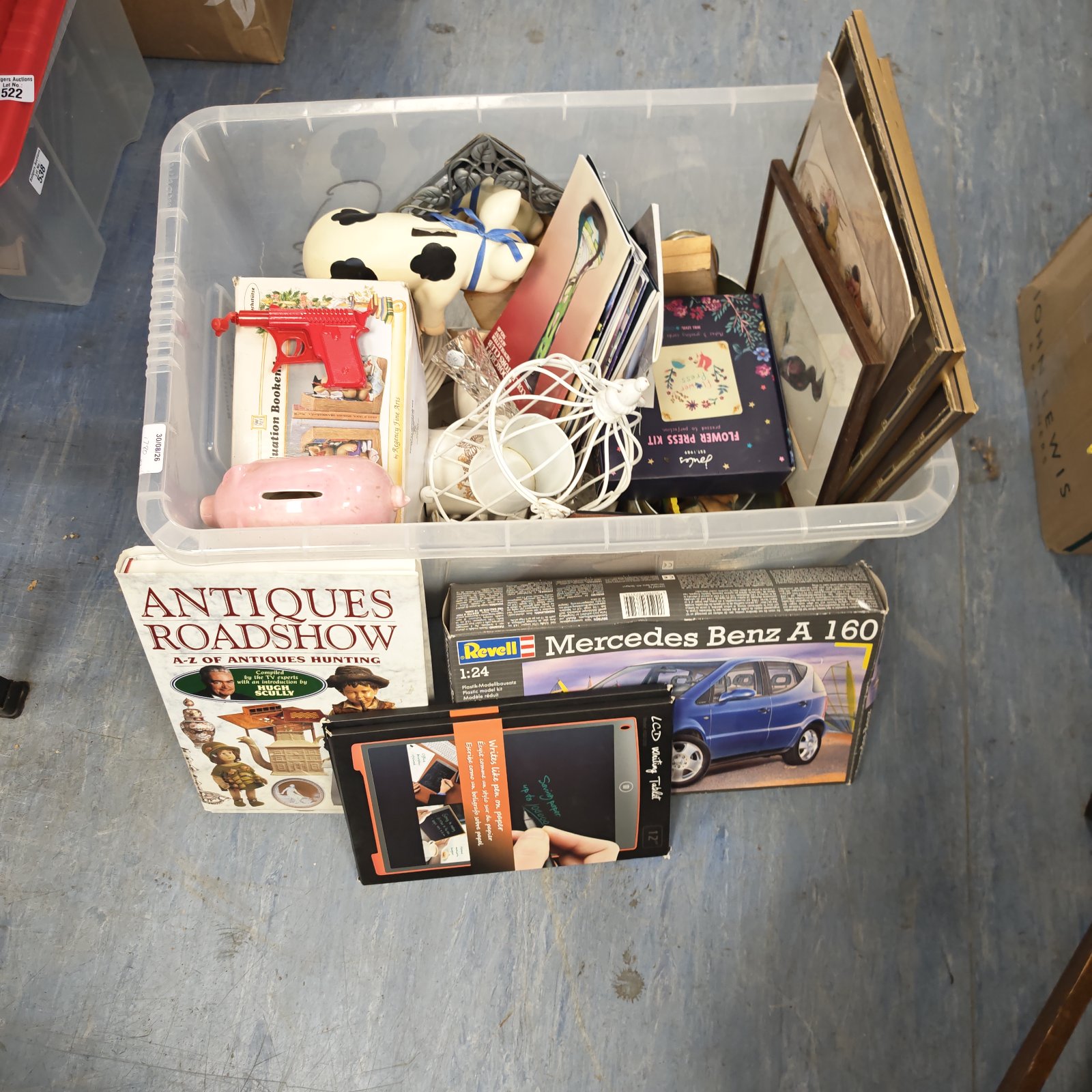 Clear box of mixed house clearance items including Antiques Roadshow book.