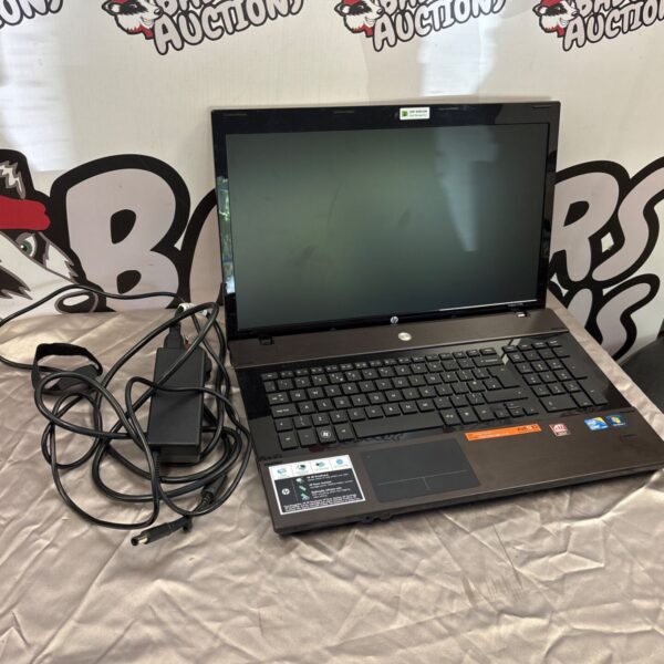 Used HP Probook 4720s laptop with charger shown in auction.