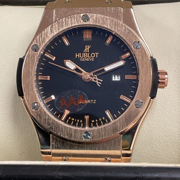 Close-up of a rose gold Hublot style quartz wristwatch.