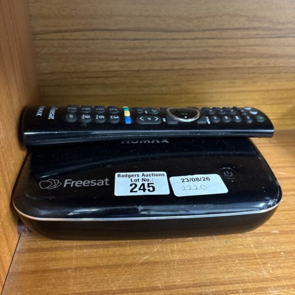 Black Humax freesat box with remote control for digital television.