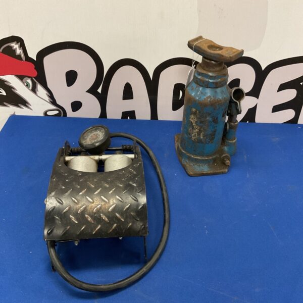 Vintage hydraulic jack and foot pump set for automotive use.