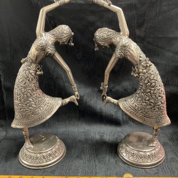 Antique Indian silver temple figures with detailed repousse work.