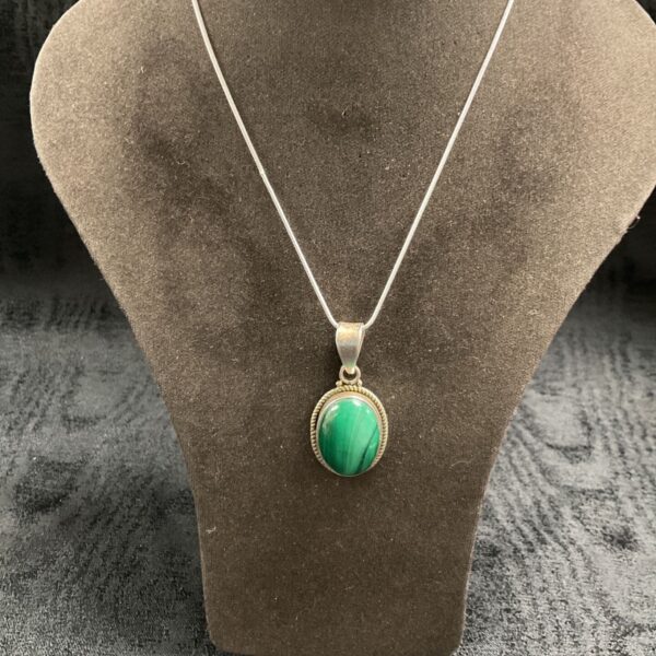 Silver pendant with polished green jade on snakelink chain.