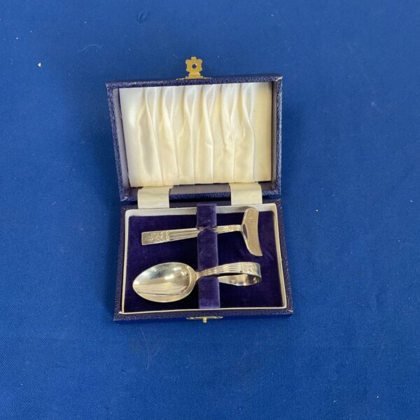 Vintage James silverplated sugar spoon and rack set displayed.